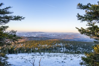 View from Mount Lusen over the hills of the bavarian forest at sunrise in winter, Bavaria, Germany