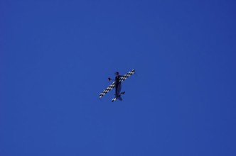 A single-engine aerobatic aircraft during a flight demonstration at the Rossfeld Luftsportverein in