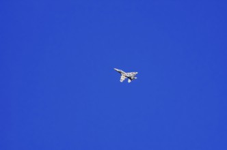 A single-jet fighter jet during a flight demonstration as part of an air show at the Rossfeld Air