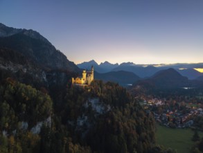 Majestic Neuschwanstein Castle at dusk, surrounded by mountains and forests, romantic lighting,