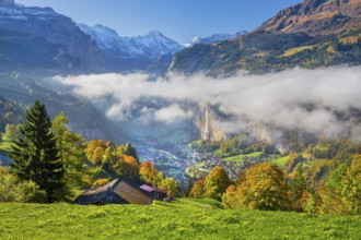 View from the village of the Lauterbrunnen Valley with Staubbach waterfall in autumn with morning