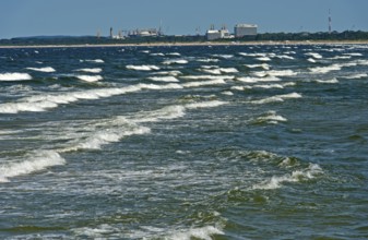 Baltic Sea waves, waves wash on the beach at the seaside resort of Ahlbeck, behind the skyline of