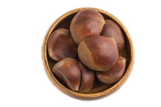 Wooden bowl with raw edible ?hestnuts Isolated on white background, top view, flat lay, close up,