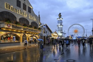 Oktoberfest visitors with umbrellas, rainy meadows, Löwenbräuturm, Ferris wheel, Munich, Bavaria,
