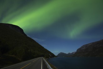 Tysfjord near Stetind Mountain in northern Norway under auroras and full moon