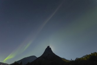 National mountain of Norway - Stetind in the Nordland under auroras and a full moon