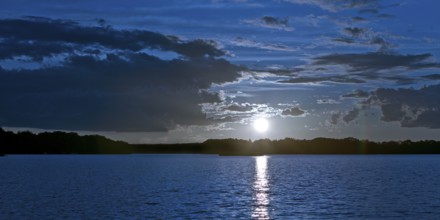 Atmospheric moonrise over Lake Gudelack, Lindow (Mark), Stechlin-Ruppiner Land nature park Park,