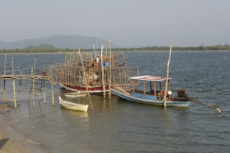 Small fishing boat on the right, boat on it lots of large bamboo traps, Phang Nga Phang-nga