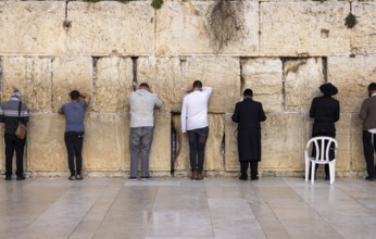 Orthodox and secular jews pray near Sacred Western Wailing Wall in Jerusalem Old City