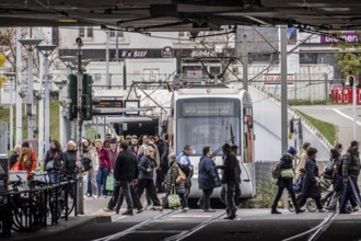 Pedestrians cross the tram tracks, at Düsseldorf-Bilk station, junction of S-Bahn, subway, tram,