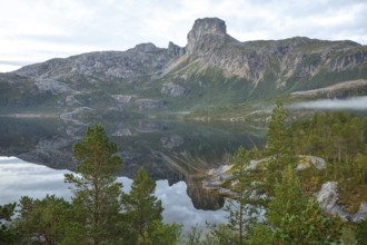 Magical morning fog on Steigtindvatnet in front of the majestic Steigtinden in Norway near Bodø