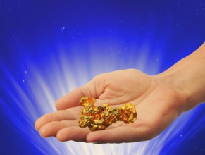 Symbolic photo, hand with gold nugget, stable value, risks, crash or upswing, financial economy,