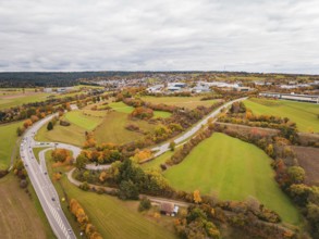 Wide landscape with winding roads, meadows and autumn atmosphere under cloudy sky, Dornstetten,