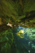 Scenario in a cave with crystal clear water and impressive rock walls, Wimsener Höhle, Hayingen,