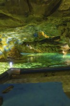 Underground scenario in a cave with shimmering green water and dramatic lighting, Wimsener Höhle,
