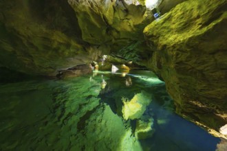 Enchanting cave with glowing water and natural rock structures in the underground, Wimsener Höhle,