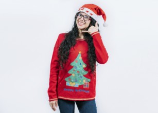 Young woman in Christmas sweater making call me gesture isolated. Beautiful girl in Christmas
