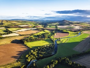 Fields and Farms over River Teviot and Minto Crags from a drone, Roxburghshire, Scottish Borders,