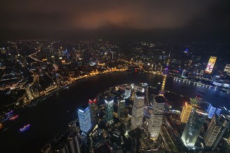 Aerial view over The Bund, Huangpu River and Lujiazui financial district with illuminated