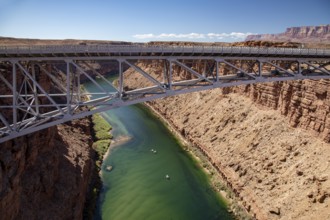Marble Canyon, Arizona - Dories float under the Navajo Bridge which spans the Colorado River in