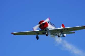 A Jakovlev Jak-52 with registration LY-HLZ during a flight demonstration as part of an air show on
