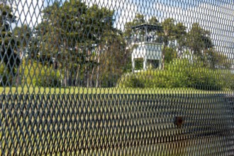 View of former area of the GDR through original GDR border fence from 1970s with death strips on