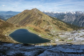 Reservoir, Kanzelwand snow-making pond, behind Fellhorn and mountains of the Allgäu Alps,