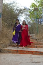 Young Indian woman on the red steps to Chamundi Hill, Mysore or Mysore, Karnataka, India