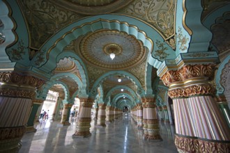 Granite columns with ornate arches and stucco ceilings, Durbar Hall in Mysuru Palace or Amba Vilas