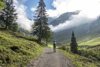Female hiker on hiking trail in the Dietersbach Valley from Gerstruben to Alpe Dietersbach,