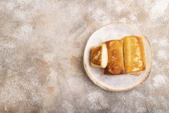 Fried crispy pancakes with meat and cheese on brown concrete background. top view, flat lay, copy