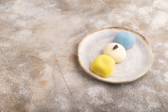 Japanese Mochi Cakes on brown concrete background, side view, copy space