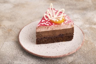 Chocolate cake on brown concrete background, side view, close up
