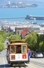 Powell-Hyde line cable car with Alcatraz Island in the background, San Francisco, California, USA