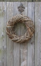 Door wreath made of natural materials on a wooden wall, North Rhine-Westphalia, Germany