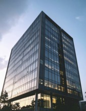 Modern building reflecting sunset light at dusk. Abstract Futuristic Business Background, AI