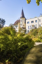 Manor house with pointed roof between thick vegetation and clear blue sky, Überlingen, Lake