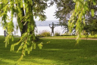 A sculpture in a peaceful park near a lake, surrounded by green nature and trees, Überlingen, Lake