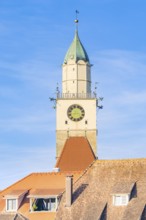 Church tower with clock over red roof tiles under clear blue sky, Überlingen, Lake Constance,