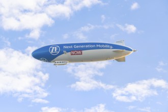 Zeppelin advertising new mobility in a blue sky with clouds, Überlingen, Lake Constance, Germany