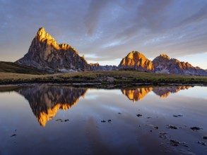 Alpine glow, reflection of the Ra Gusela and Tofane mountains at sunrise, Passo di Giau, Giau Pass,