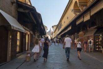 Ponte Vecchio, jewelry stores, dome of Santa Maria del Fiore Cathedral in the background, Florence,