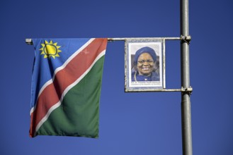 Namibian flag and image of President Dr. Netumbo Nandi-Ndaitwah on a street lamp, Windhoek, Khomas