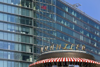 Historic Café Kranzler logo with modern office building and H&M logo on Kurfürstendamm,