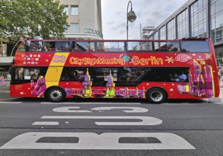 Double-decker bus for the city tour on Tauentzienstraße with Kaiser Wilhelm Memorial Church,