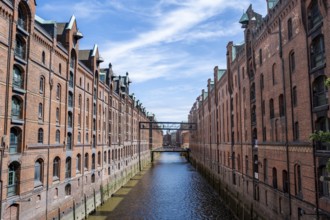 Canal between red brick buildings, warehouses in Hamburg's Speicherstadt, Hamburg, Germany