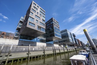 Modern residential buildings, traditional shipping harbor on Sandtorkai, behind Elbphilharmonie,