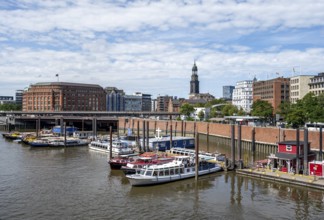 Boats in the inland port at the mouth of the Alster, St. Michaelis church in the back, Hamburg,