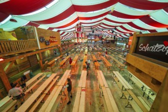 Large marquee with red ceilings and wooden benches, Bavarian atmosphere and decoration, Volksfest