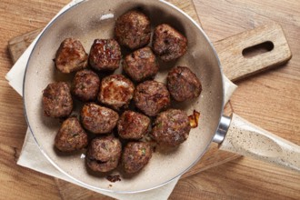 Fried meatballs in a frying pan, homemade, no people